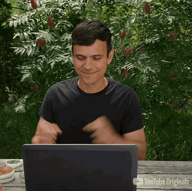 a man sitting in front of a laptop that says youtube originals on the bottom