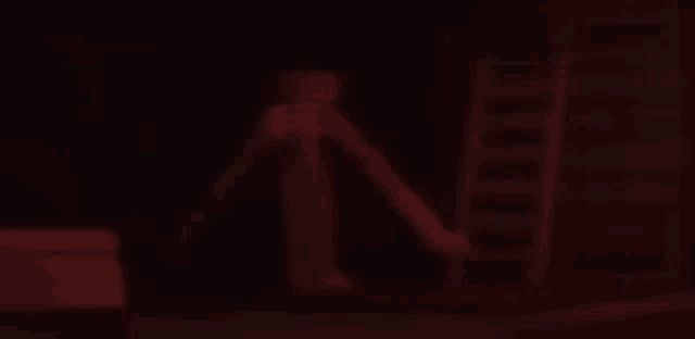 a red skeleton is standing in the dark with a ladder in the background .