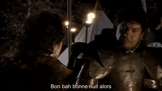 a man in armor talks to another man with the words qu'est ce que ca veut dire ca