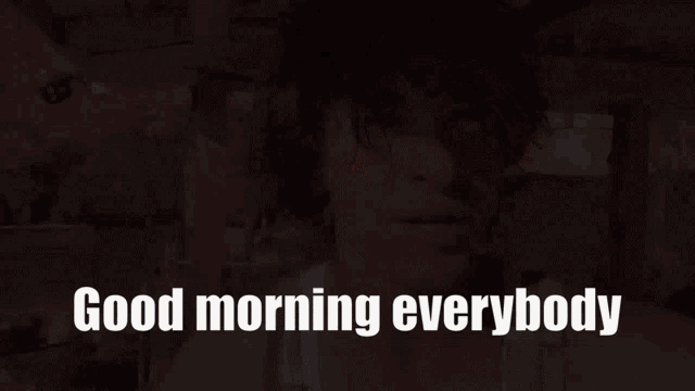 a man says good morning everybody in front of a fence