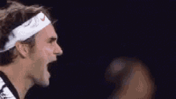 a close up of a tennis player wearing a headband and screaming .