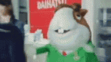 a stuffed animal is wearing a green shirt and tie .