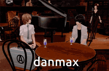a couple of people sitting at a table with the word danmax on the table