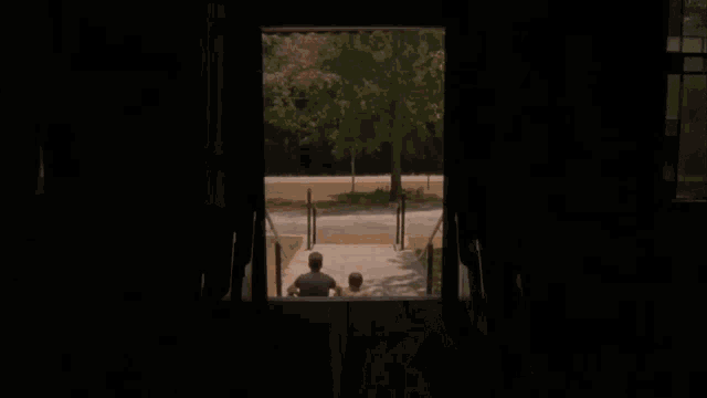 a man in a cowboy hat stands on a set of stairs next to two other men