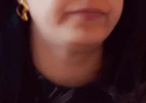 a close up of a woman 's face with a blurred background