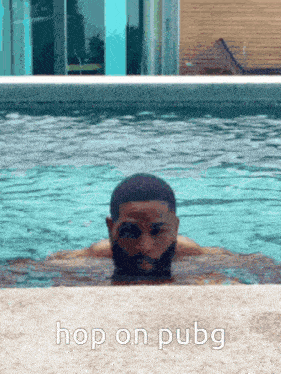 a man is swimming in a pool with the words hop on pubg on the bottom