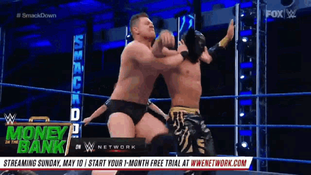 two men are wrestling in a wrestling ring with the words money bank on the bottom