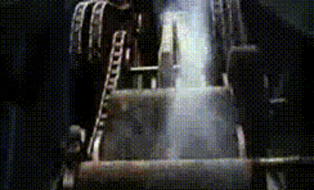 a person standing on a ladder in a dark room with smoke coming out of it .