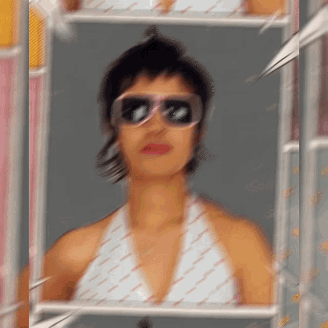 a blurred image of a woman wearing sunglasses