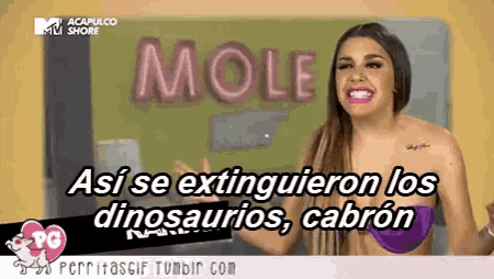 a woman in a bikini stands in front of a wall that says mole