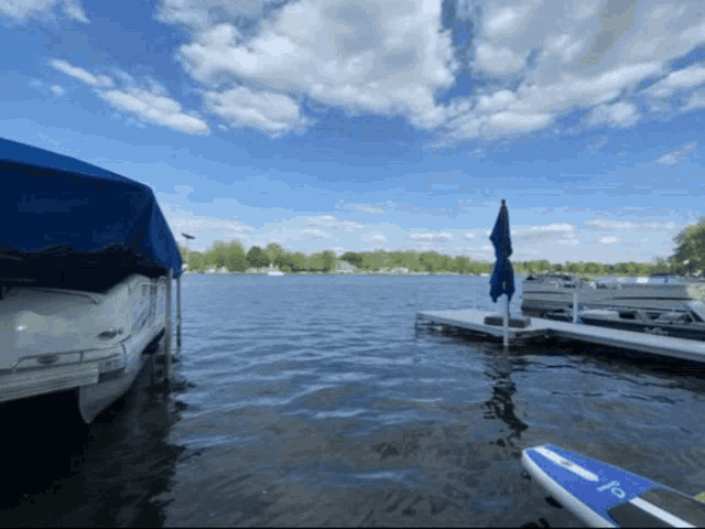 a blue and white paddle board with the letter f on the side