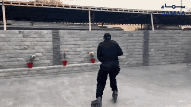 a man rollerblading in front of a wall with the word samaa on it