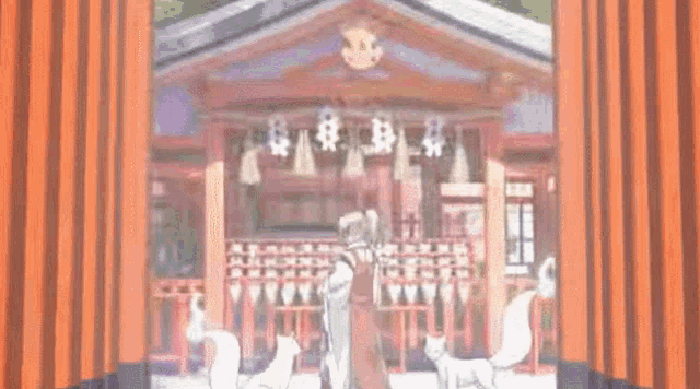 a man and a woman are standing in front of a building with foxes .
