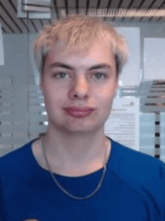a young man is wearing a blue shirt and a chain around his neck .