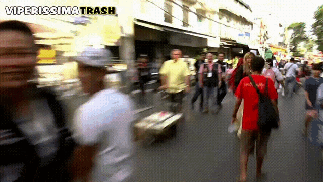 a group of people are walking down a street with the words viperissima trash written above them