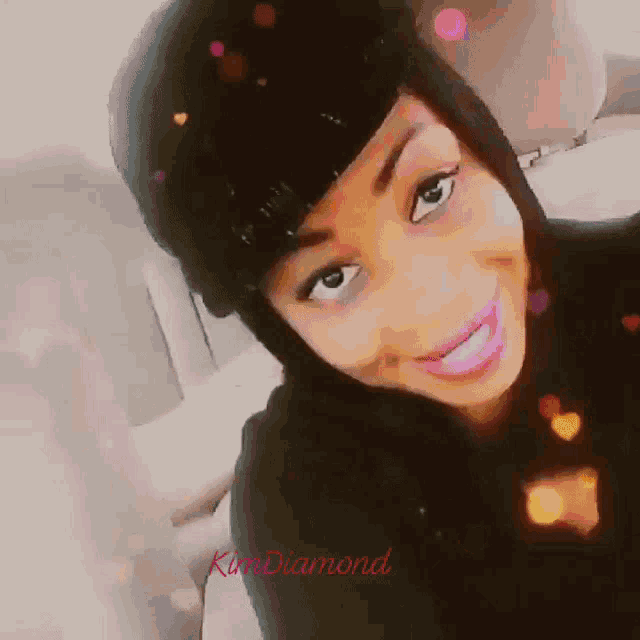 a woman wearing a black hat and pink lipstick has the name kim diamond on the bottom