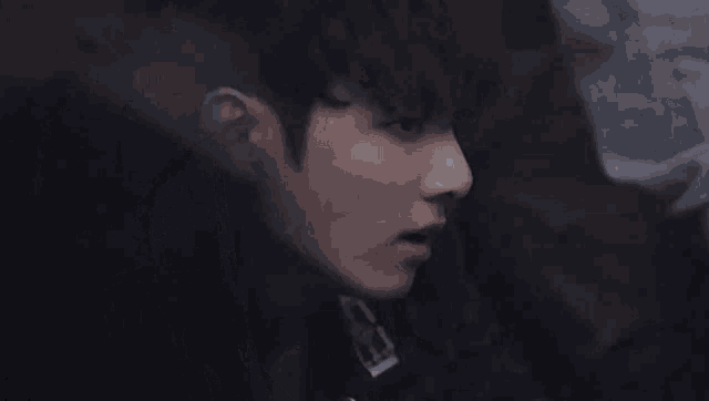 a close up of a man 's face with a bandana on his neck