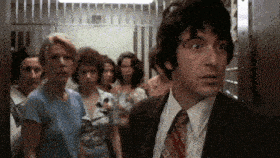 a man in a suit and tie stands in front of a group of women