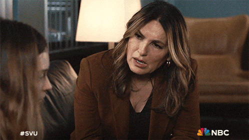 a woman in a brown jacket is talking to another woman with a nbc logo in the corner
