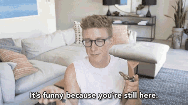 a man holding a fidget spinner says it 's funny because you 're still here ..