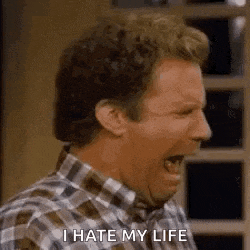 a man in a plaid shirt is screaming with his mouth open and says `` i hate my life '' .