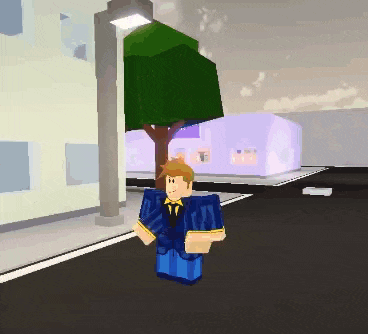 a man in a blue suit and tie is walking down a street .
