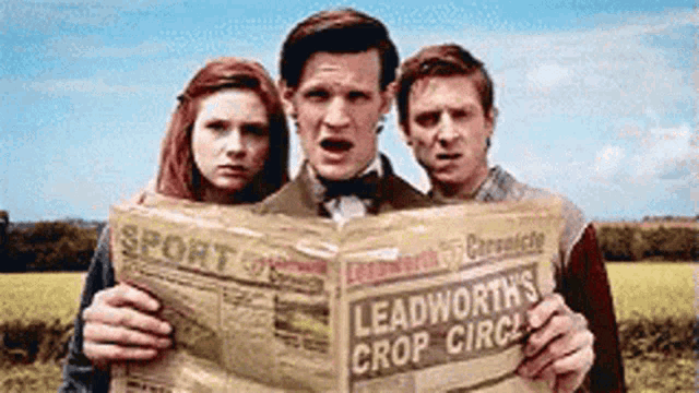 three people holding a newspaper that says leadworth 's crop circus on it