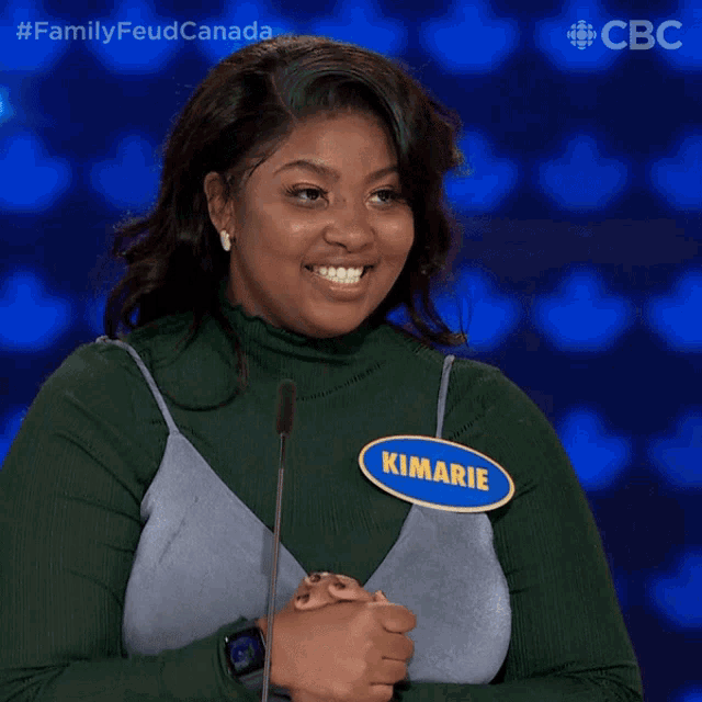 a woman with a name tag that says kimarie stands in front of a microphone