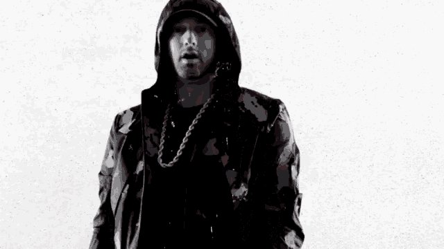 a black and white photo of a man wearing a camo jacket