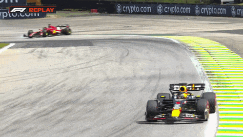 a race car is going down a track with a crypto.com banner in the background