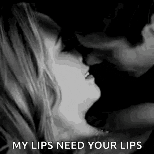 a man and woman are kissing in a black and white photo with the words `` my lips need your lips '' .
