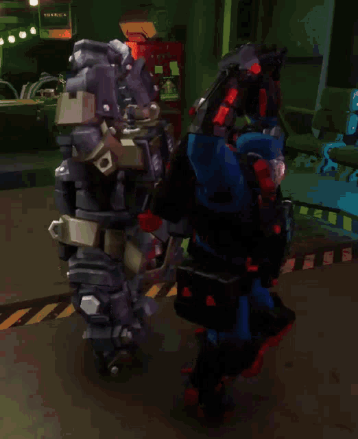 two robots are standing next to each other and one of them has a red light on its head
