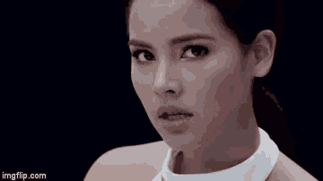 a close up of a woman 's face with a white collar and a black background .