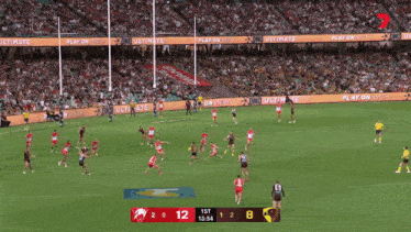 a soccer game is being played in front of a crowd and the score is 12 to 8