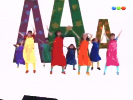 a group of children are standing in front of the letter aa