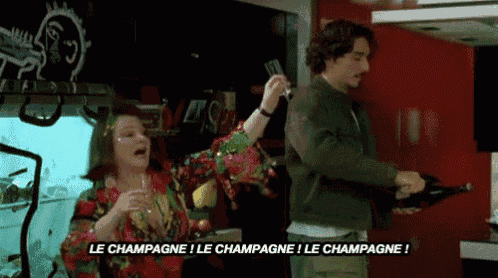 a man is pouring champagne into a glass while a woman holds a glass of champagne