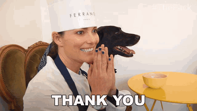 a woman in a chef 's hat says thank you to a dog