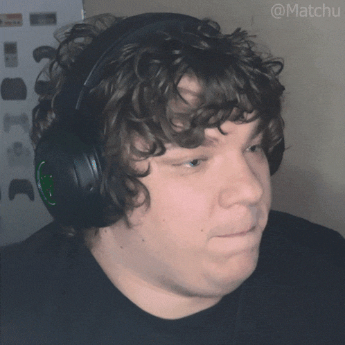 a man with curly hair wearing headphones with the hashtag @matchu on the bottom