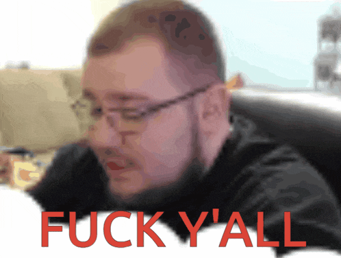 a blurry picture of a man with glasses and the words fuck y'all in red