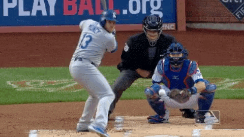 a baseball player with the number 13 on the back of his jersey swings at a pitch
