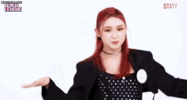 a woman with red hair is wearing a polka dot dress and a name tag that says statv .