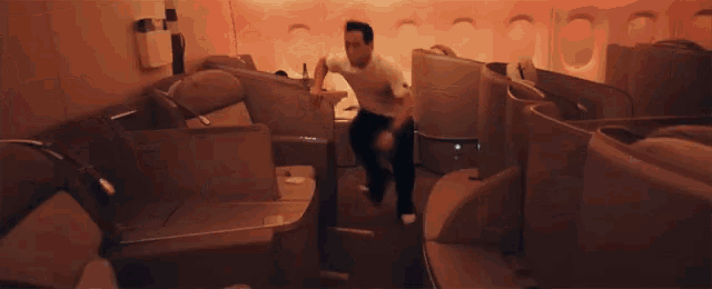a man is sitting on a chair in an airplane with the hashtag #parkour on the bottom