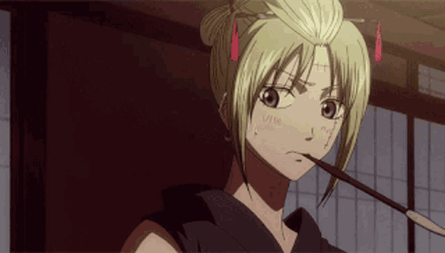 a blonde anime girl with a stick in her mouth looks angry