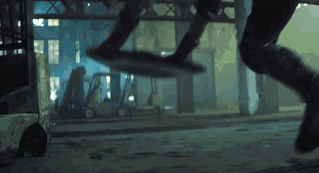 a person is jumping in the air with a forklift in the background and the number 20 is visible
