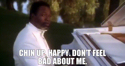 a man in a white suit is playing a piano and says `` chin up , happy , don 't feel bad about me ''