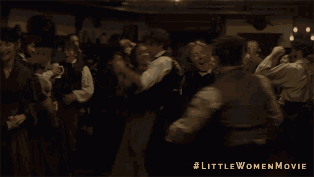 a group of people are dancing in a dark room with #littlewomenmovie written on the bottom right