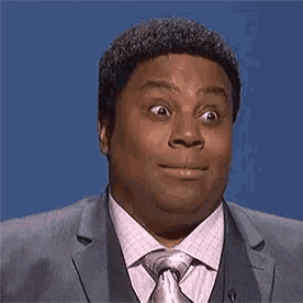 a man in a suit and tie is making a face