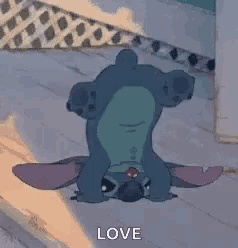 a cartoon character is laying upside down on the floor with the word love written on the bottom .