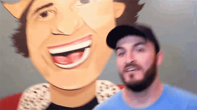 a man in a blue shirt is standing in front of a cartoon drawing of a man