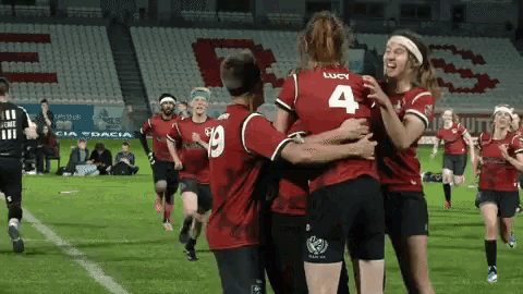 a group of soccer players are hugging each other with one wearing the number 4